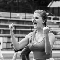 Chelsea Farley with her fists in the air, mouth open, cheering and celebrating